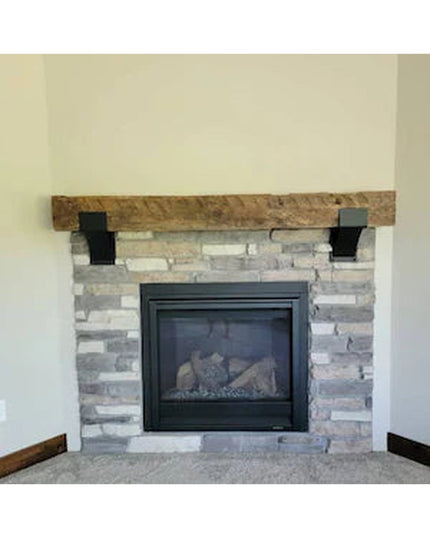 Rustic wooden Otisco Farmhouse Style Brackets by Industrial Farm Co supporting reclaimed wood mantel above stone fireplace