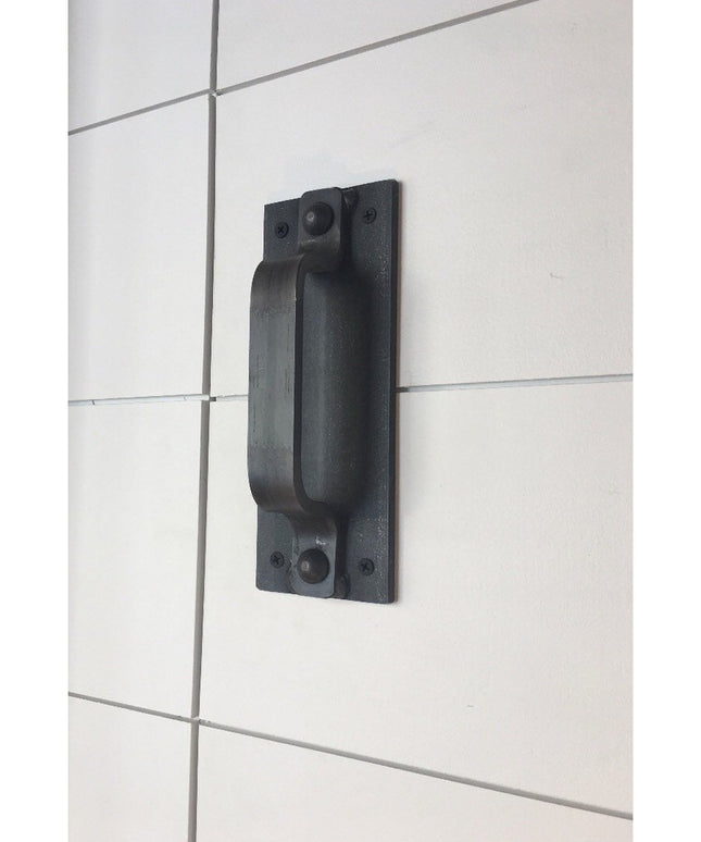 Black iron Corning Handle door pull mounted on white tiled wall, showing industrial farmhouse style hardware by Industrial...