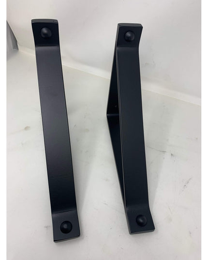 Two black metal Joyce Modern Shelf Support brackets by Industrial Farm Co with sleek angular design and rounded mounting h...
