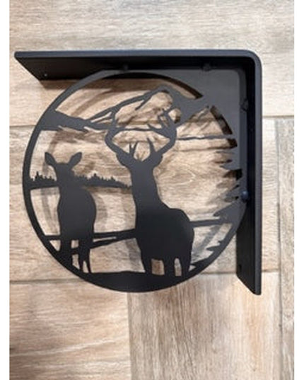 Black metal L-bracket shelf support featuring deer silhouette in circular woodland scene design against natural wood backg...