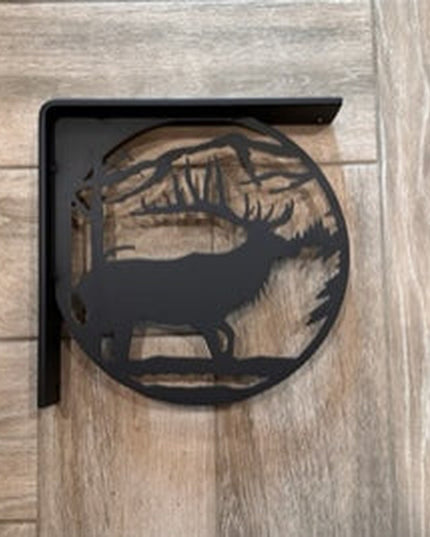 Black metal elk silhouette L-bracket shelf support mounted on light wood wall by Industrial Farm Co, showing rustic handcr...